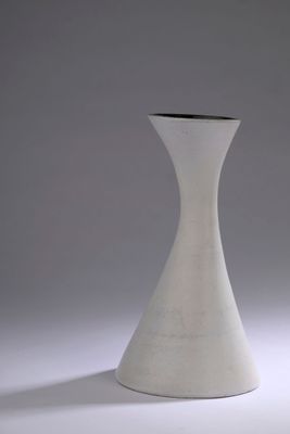 a white vase that is sitting on a table
