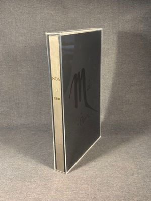a close up of a book on a table with a gray background