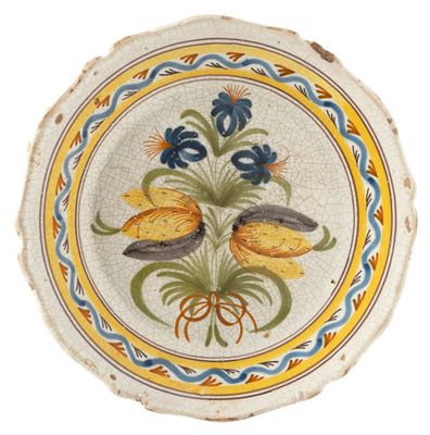 a decorative plate with flowers on it on a white background