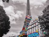 the eiffel tower is covered in graffiti on the side of the road
