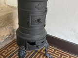 an old stove sits on a tiled floor in a room
