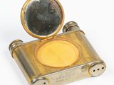 a small metal box with a mirror on it