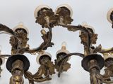 a gold colored chandelier with many lights on it