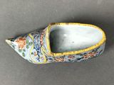 pair of chinese clogs with floral decoration on them