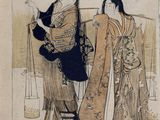 two women in kimono robes sitting on a bench in front of a tree