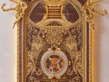 an image of a gold clock with a crown on top of it