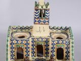 a ceramic figurine of a building with a clock tower