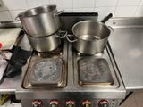 pots and pans sit on top of a stove in a kitchen