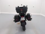 a motorcycle parked in a room with a license plate on the back of it