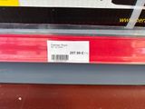 a picture of a red and white sign on a store shelf