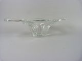 a clear glass bowl with a handle on a white surface