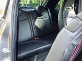 a black car with pink stitching in the back seat