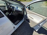 a white car with its door open on the street