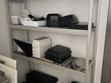 a metal shelving with many different types of electronics on it