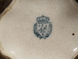 a close up of a vase with a blue and white design