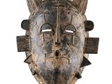 an image of a wooden mask with horns on a white background