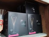three boxes of champagne glasses on a shelf