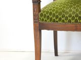 a chair with a green upholstered upholstered upholstered upholstered upholstered upholstered upholstered