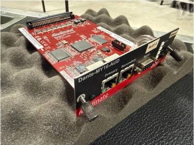 une photo d'une carte PCI-E rouge et noire posée sur une couverture