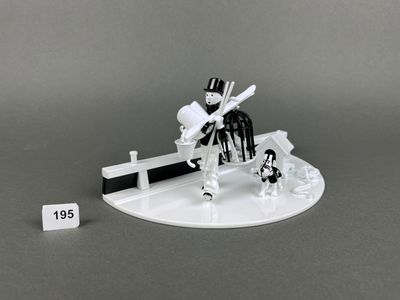 a small figurine of a man sitting on a bench
