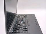 a black laptop with a blue keyboard on a white surface