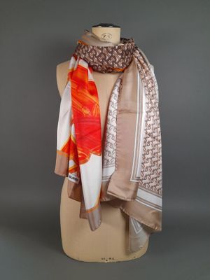 an orange and white scarf on a mannequin dummy