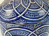 a blue and white vase sitting on a table