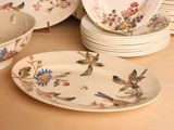 many plates and bowls that are sitting on a table