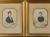 two framed portraits of a boy and a girl in a green dress