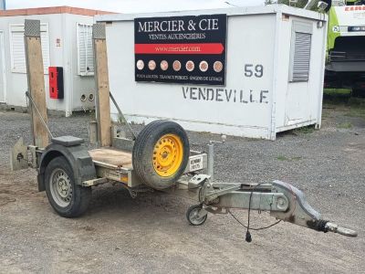 a trailer with a trailer attached to it in a parking lot