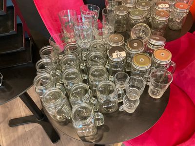 a table with a lot of empty mason jars on it
