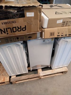 many boxes of white appliances stacked on top of each other