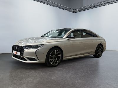 a silver car is parked in a large room with a white wall
