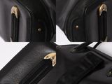 three pieces of black luggage sitting next to each other on top of a white surface