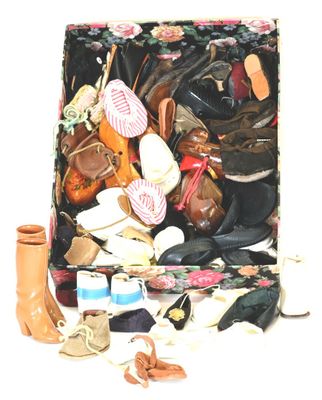 many pairs of shoes and hats in a suitcase