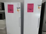 two refrigerators that are sitting side by side in the kitchen