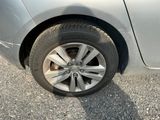 a cat that is sitting on the tire of a car