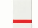 un cahier blanc et rouge avec une bande rouge sur la couverture