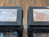 two tables that have marble tops on them on a wooden floor