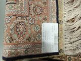 a large oriental rug with fringes on the floor