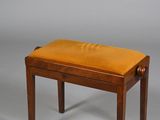 an image of a small wooden bench with a leather seat