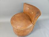 a brown chair that is sitting on a white surface