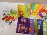 several children ' s books are lined up on a table