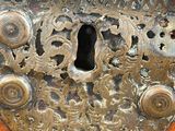 a close up of a metal lock on a wooden door