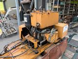 a yellow machine that is sitting in a garage