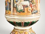 a large vase with a painting on it on display