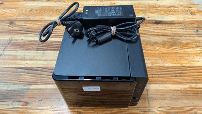 a close up of a small black box on a wooden table