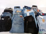 a lot of jeans stacked on top of each other