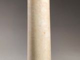 a white vase that is sitting on a table