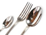 three spoons and two spoons sitting on a table